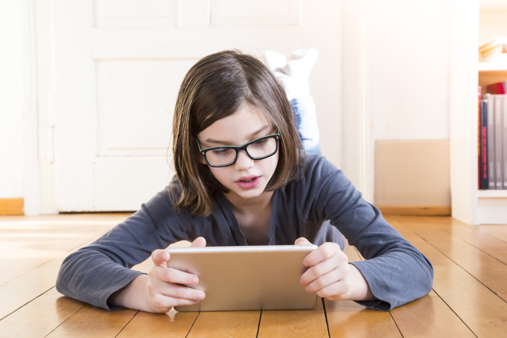 girl with glasses and ipad