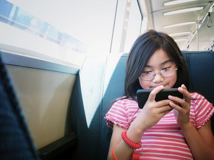 Asian kid on smartphone