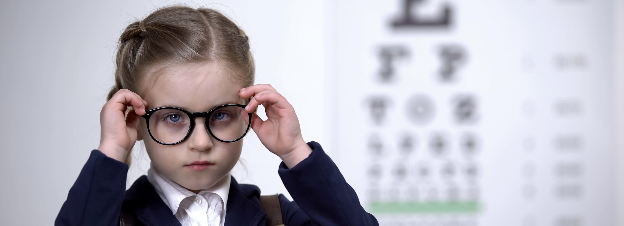 Sad schoolgirl taking off glasses, disgruntled with sight problems, eye illness