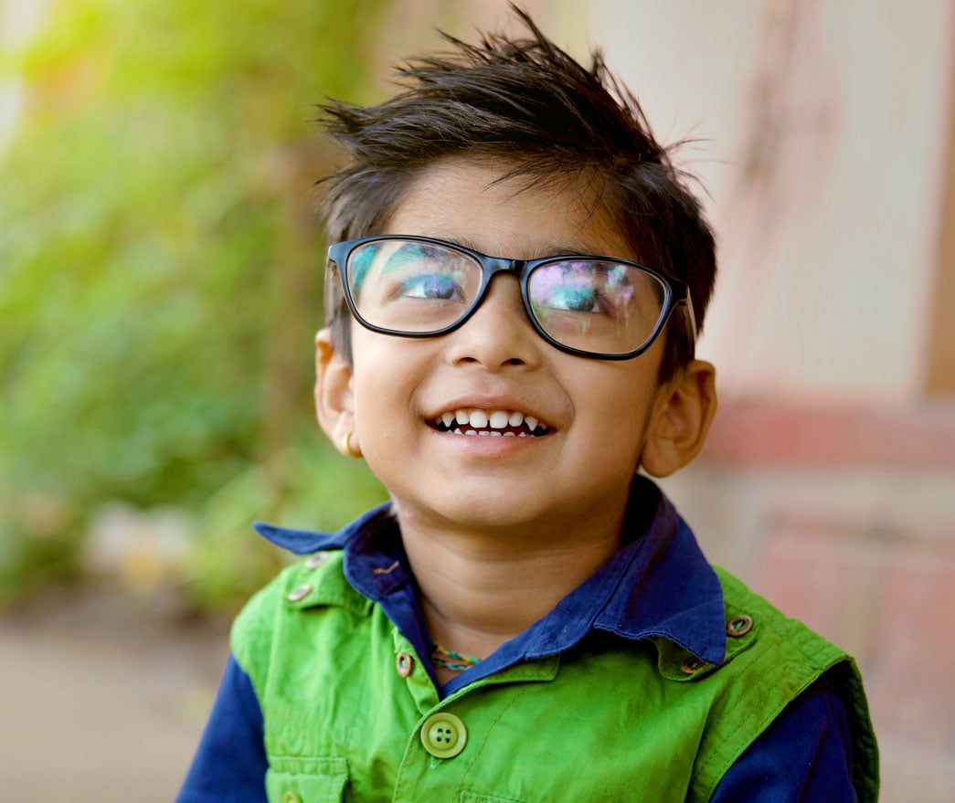 Child in glasses smiling
