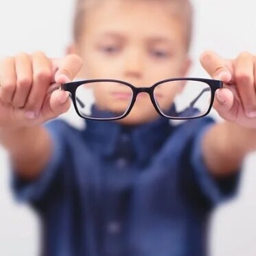 boy-holding-an-eyeglasses