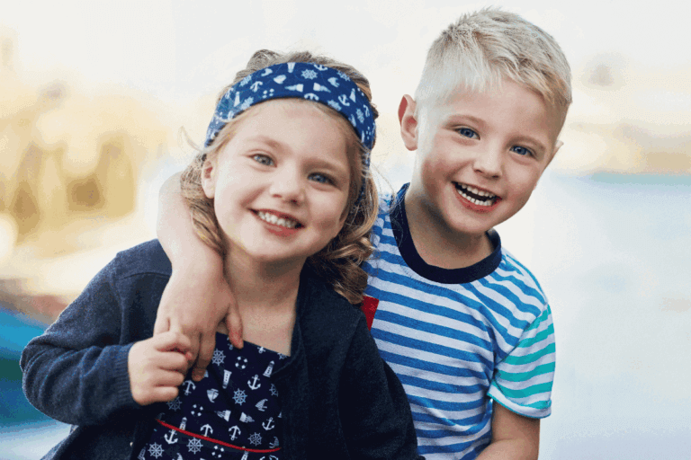 Two children holding MiSight 1 day disposable contact lenses, available for myopia control in Los Angeles, CA .