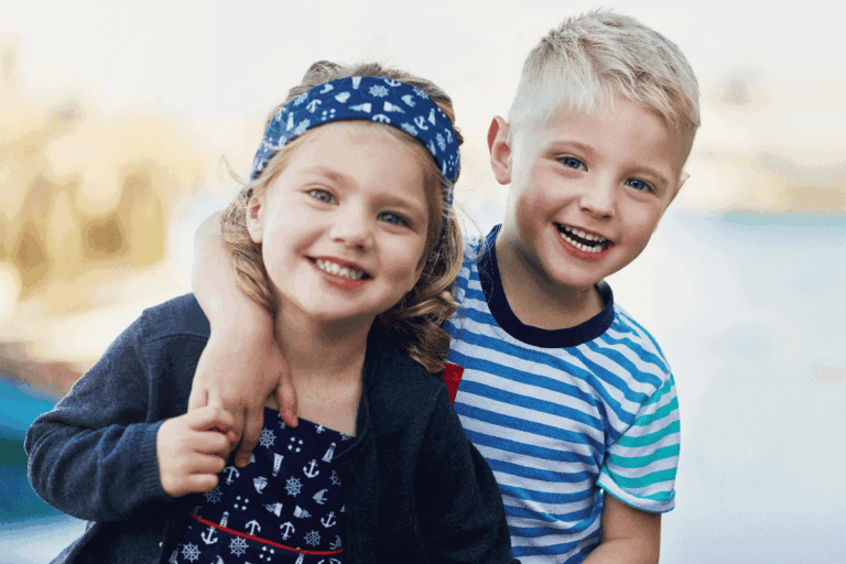 Two children holding MiSight 1 day disposable contact lenses, available for myopia control in Tulsa, OK.